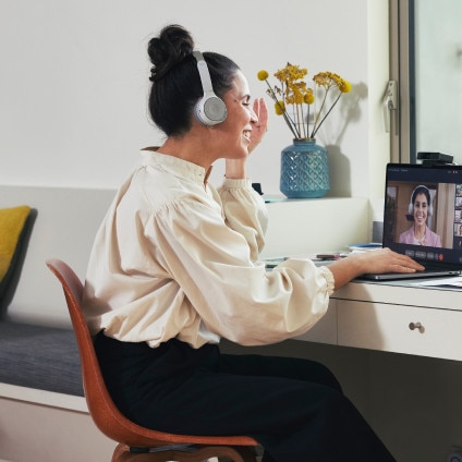 Person at desk using desktop device for a video call